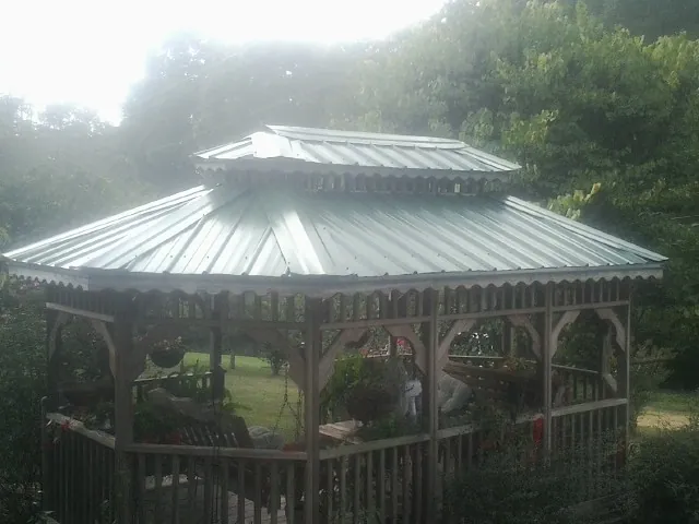 Two tier green metal roof on a garden gazebo in Oak Hill